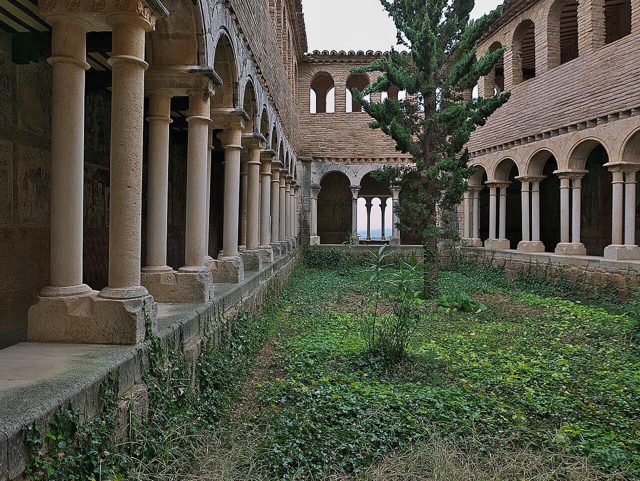 Stone columns and brick arcades around the collegiate church cloister in Alquézar