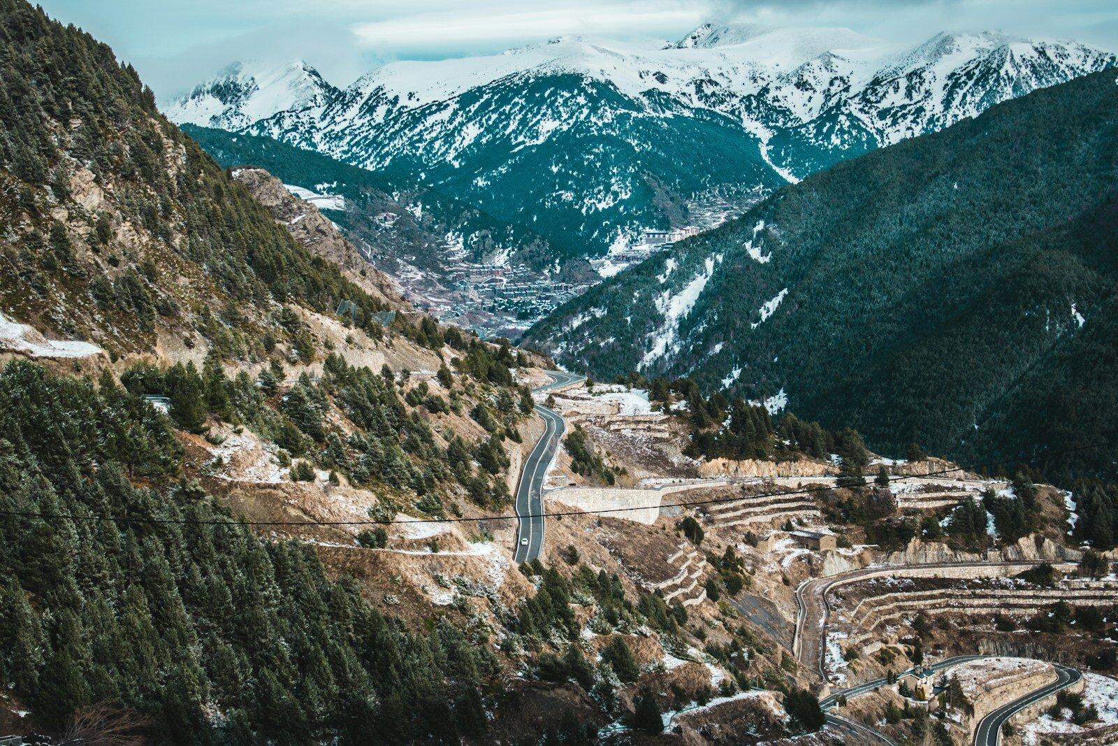 Coach following a winding road through the Andorran mountains