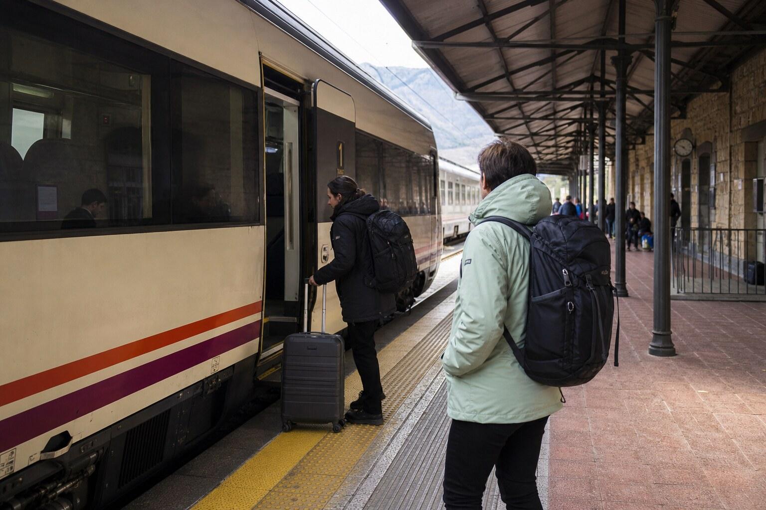 Travelers boarding a regional train on the cross-border route